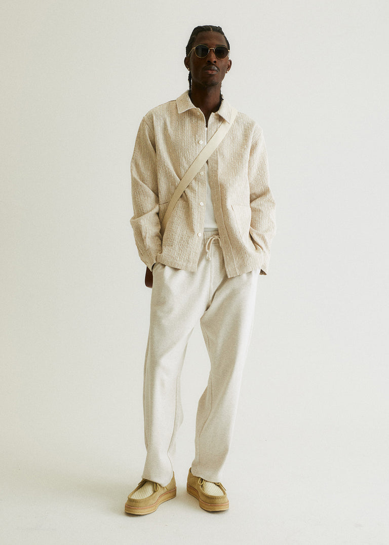 
            A model wearing an overshirt, sweatpants, shirt, and bag from Kith Spring Delivery I 2024.
          
