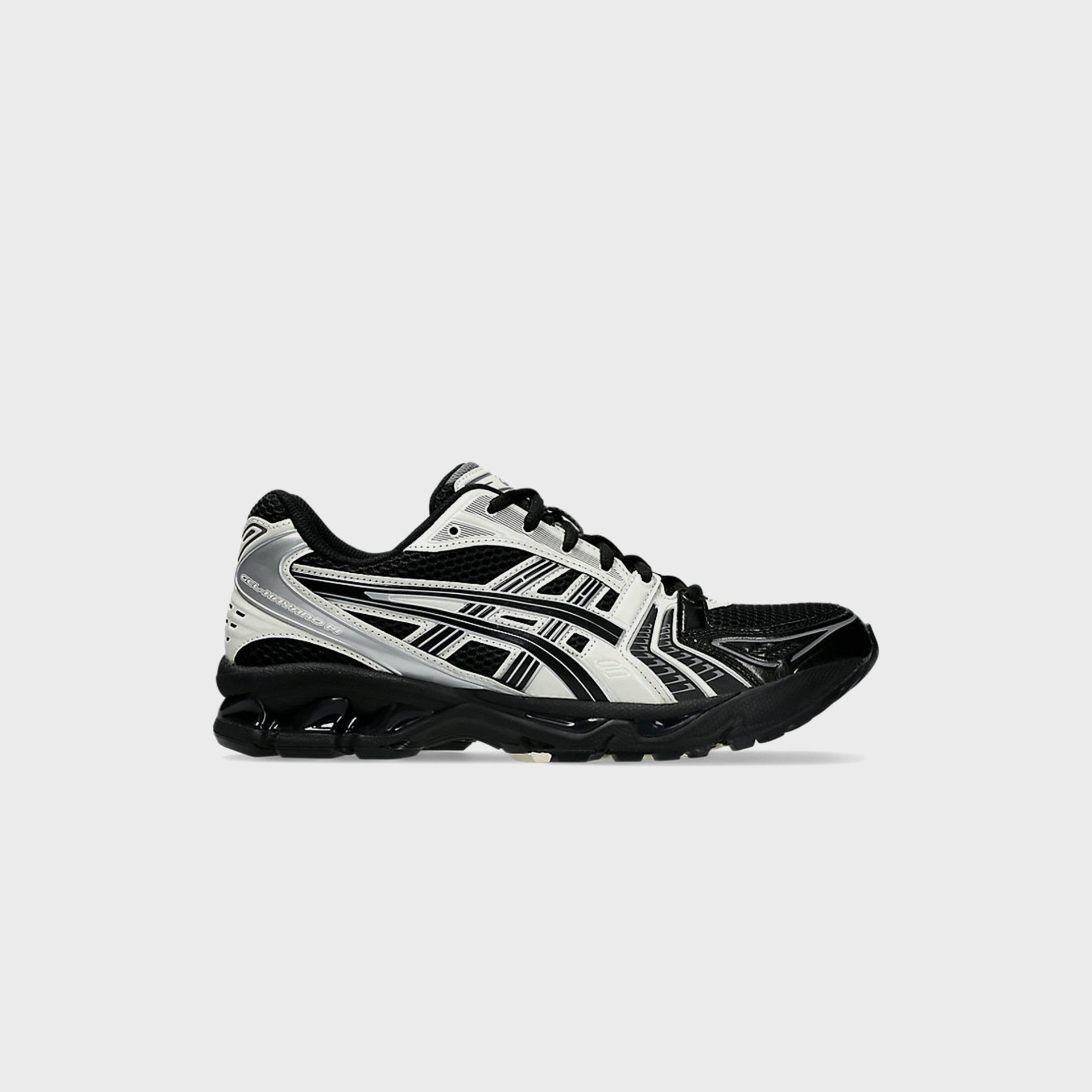 ASICS GEL-KAYANO 14 in Black and Cream, lateral side view with silver accents and black sole