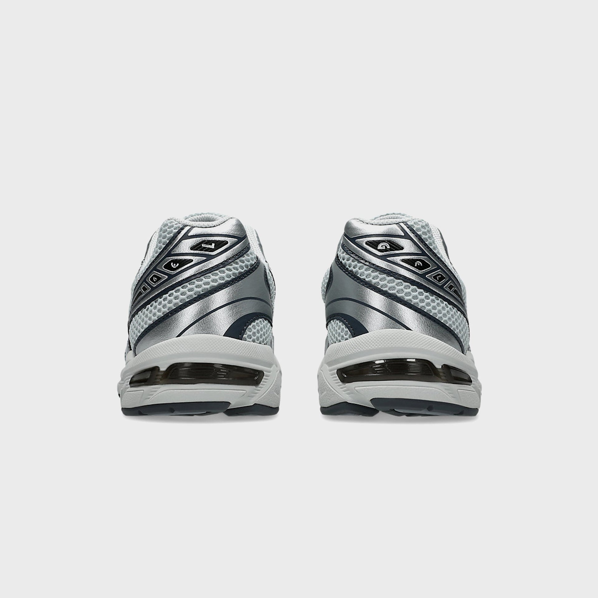 ASICS GEL-1130 in silver and grey, back heel view of pair with navy accents and white midsole