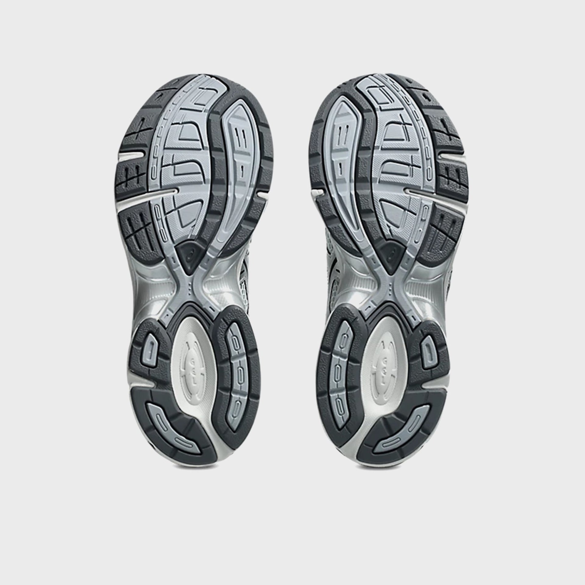 ASICS GEL-1130, bottom outsole view of pair with grey and black tread and GEL cushioning