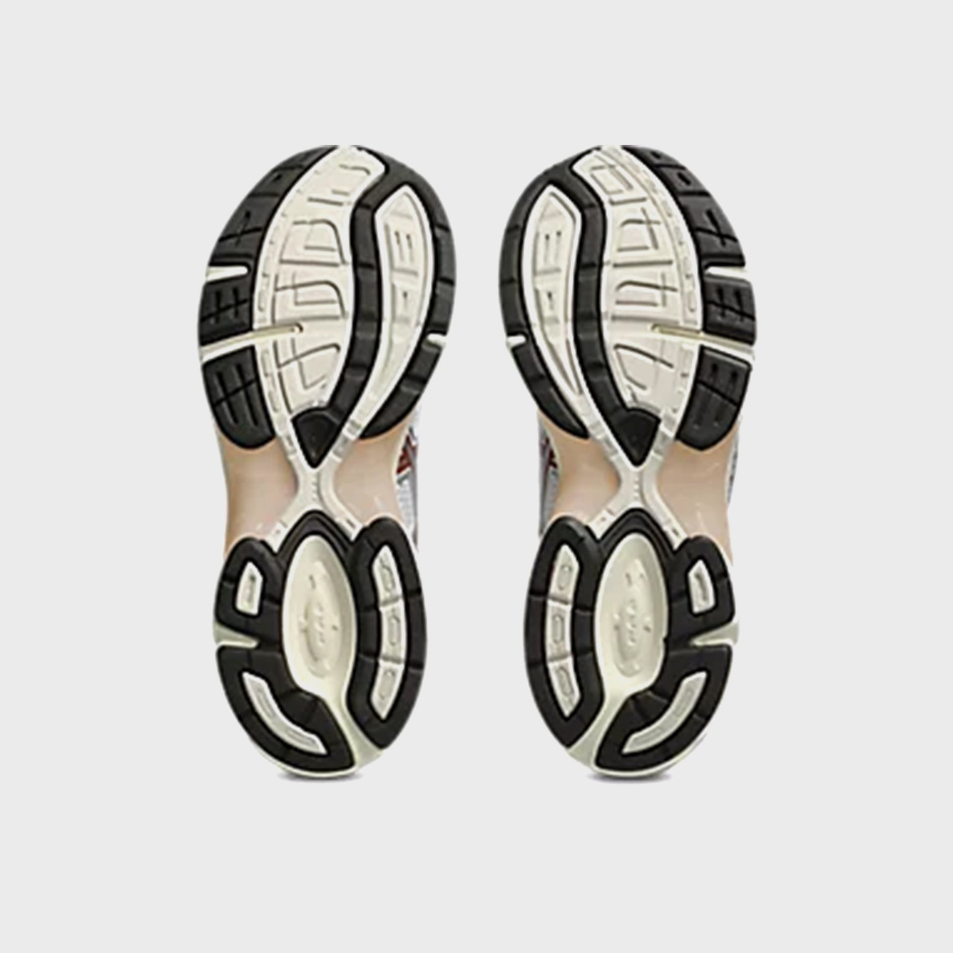 ASICS GEL-1130 in White and Rusted Rock, bottom view of the black and cream rubber outsole tread