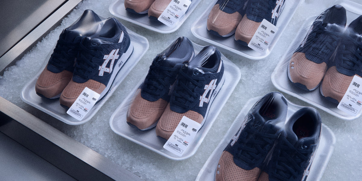 Multiple pairs of Kith for ASICS GEL-LYTE III sneakers in tan and navy suede, displayed in foam trays on ice, wide overhead view