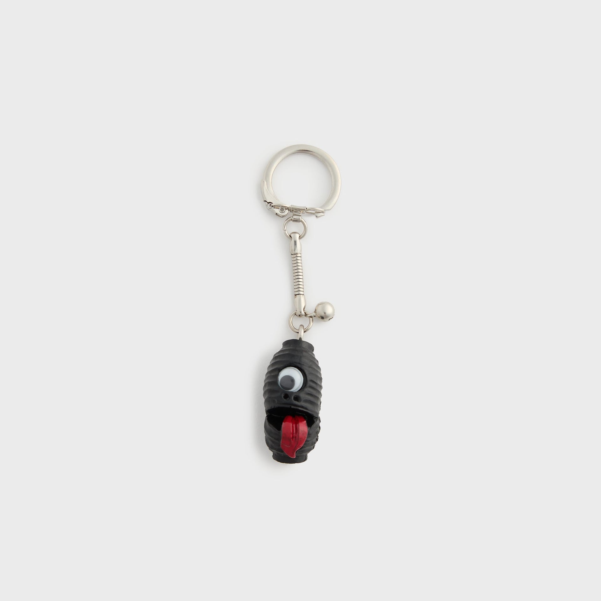WTAPS x Masa Sculp Bonanza black resin key chain with googly eye and red tongue creature charm on silver ring, full view
