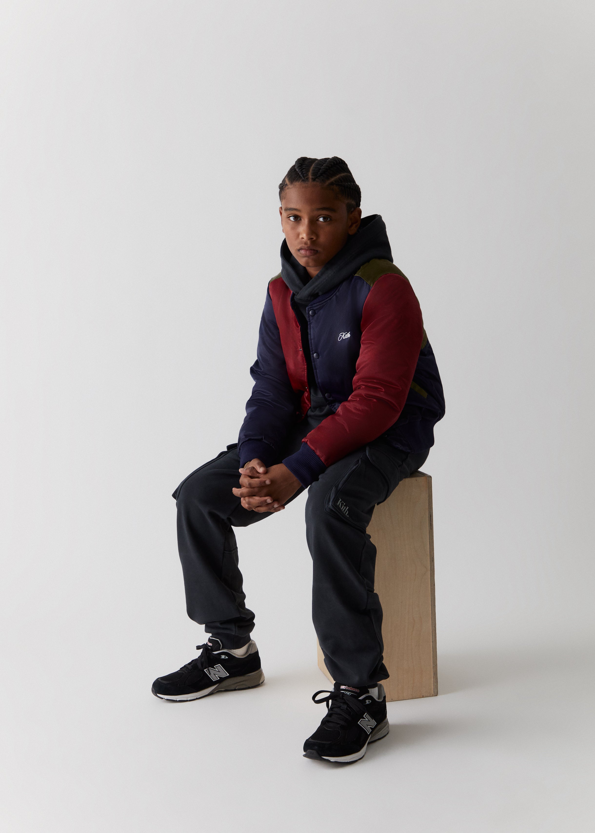 A child wearing a color-blocked varsity style jacket from the Kith Kids Fall Classics 2023 collection.
