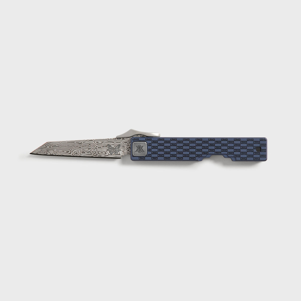 Kith x Benchmade Yamori Nocturnal folding knife open, Damascus wharncliffe blade beside navy titanium handle with KITH checker pattern