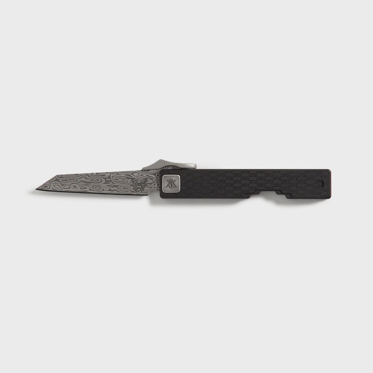 Kith x Benchmade Yamori knife in Black, open with Damascus wharncliffe blade beside the black titanium KITH checker-pattern handle