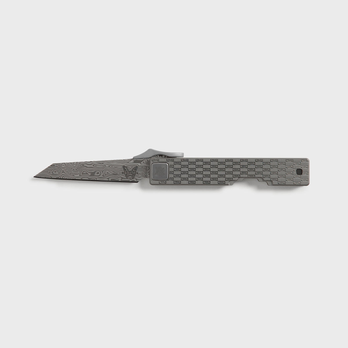 Kith x Benchmade Yamori knife in Drift, open with Damascus wharncliffe blade beside the gunmetal grey KITH checker-pattern handle