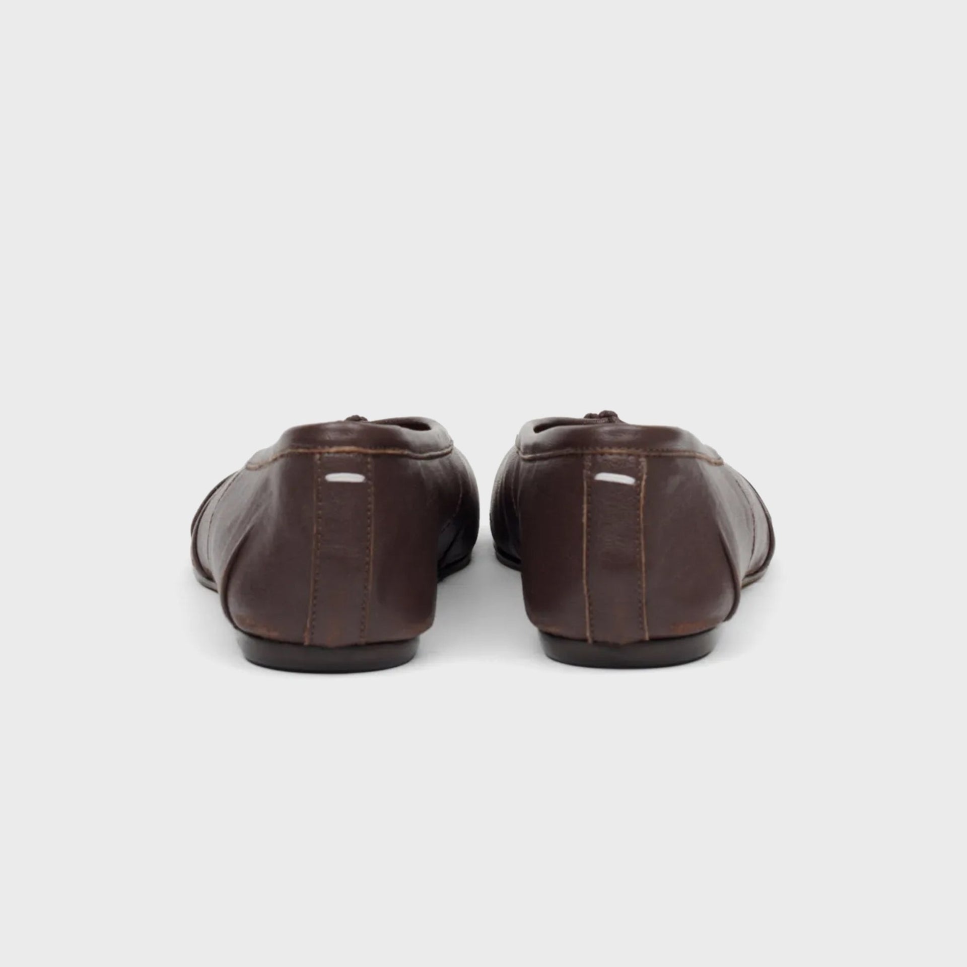 Pair of Maison Margiela WMNS Tabi ballerina flats in brown leather, rear heel view showing tonal topstitching