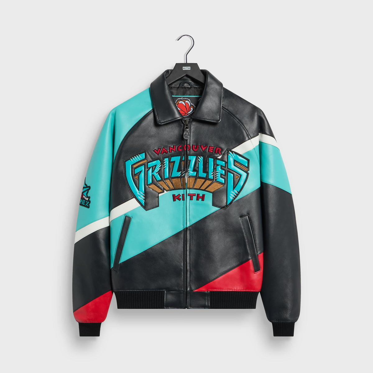 Kith & AVIREX Vancouver Grizzlies leather jacket in black, teal and red color-block, front view with embroidered Grizzlies logo on hanger