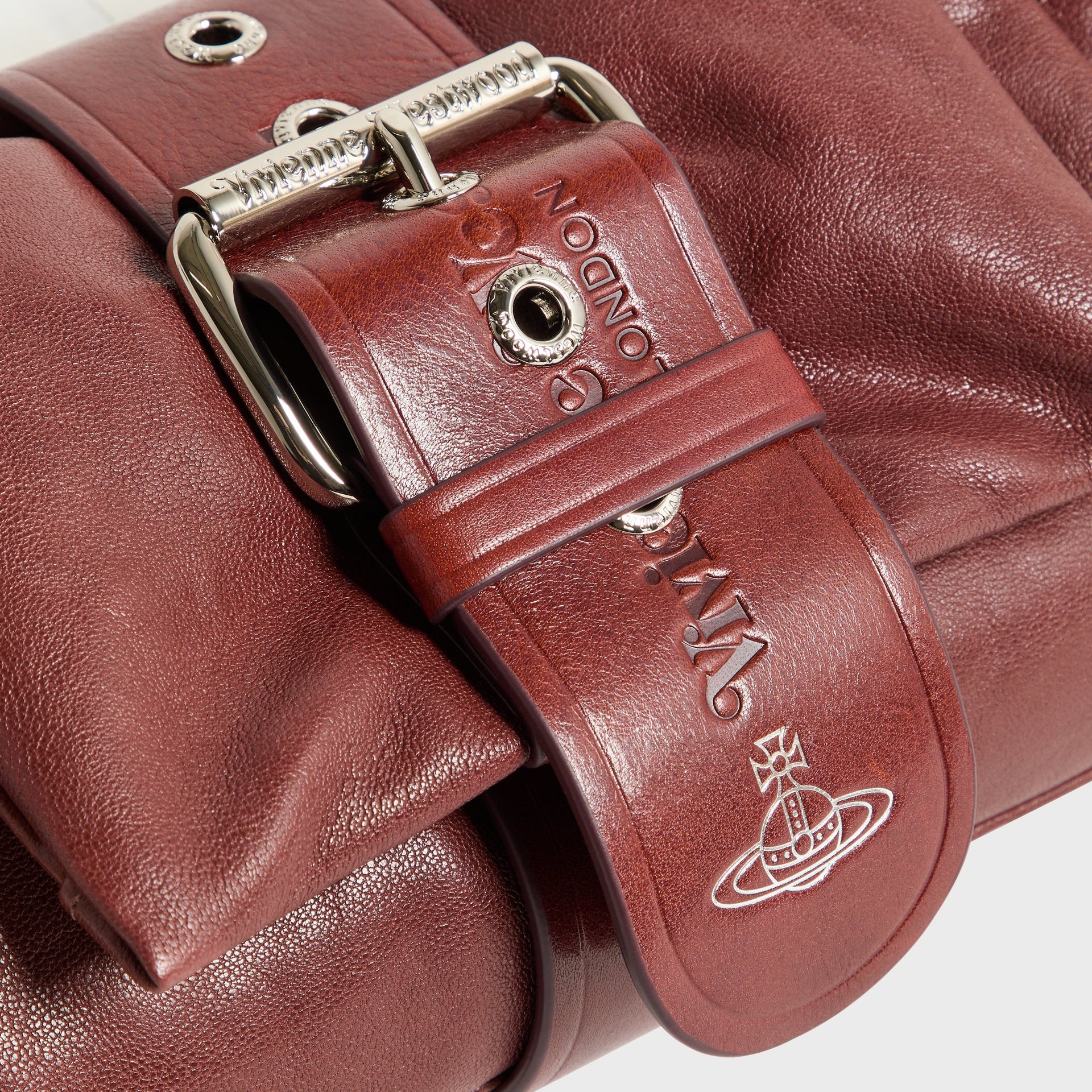 Vivienne Westwood Hazel Treasure Handbag detail: silver buckle and embossed orb logo on chestnut leather strap