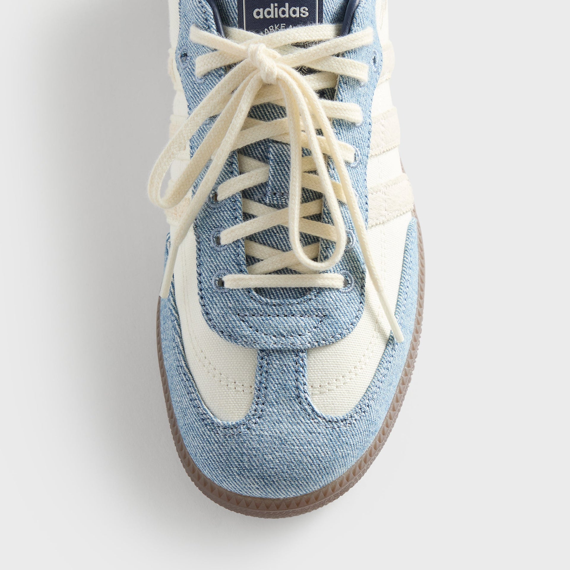 Close-up of the toe box and denim laces on the Kith for adidas Originals Samba "Denim" sneaker