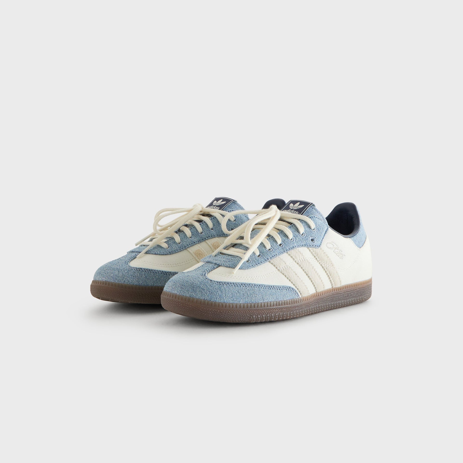 Pair of Kith for adidas Originals Samba "Denim" sneakers in white and denim, three-quarter angle view