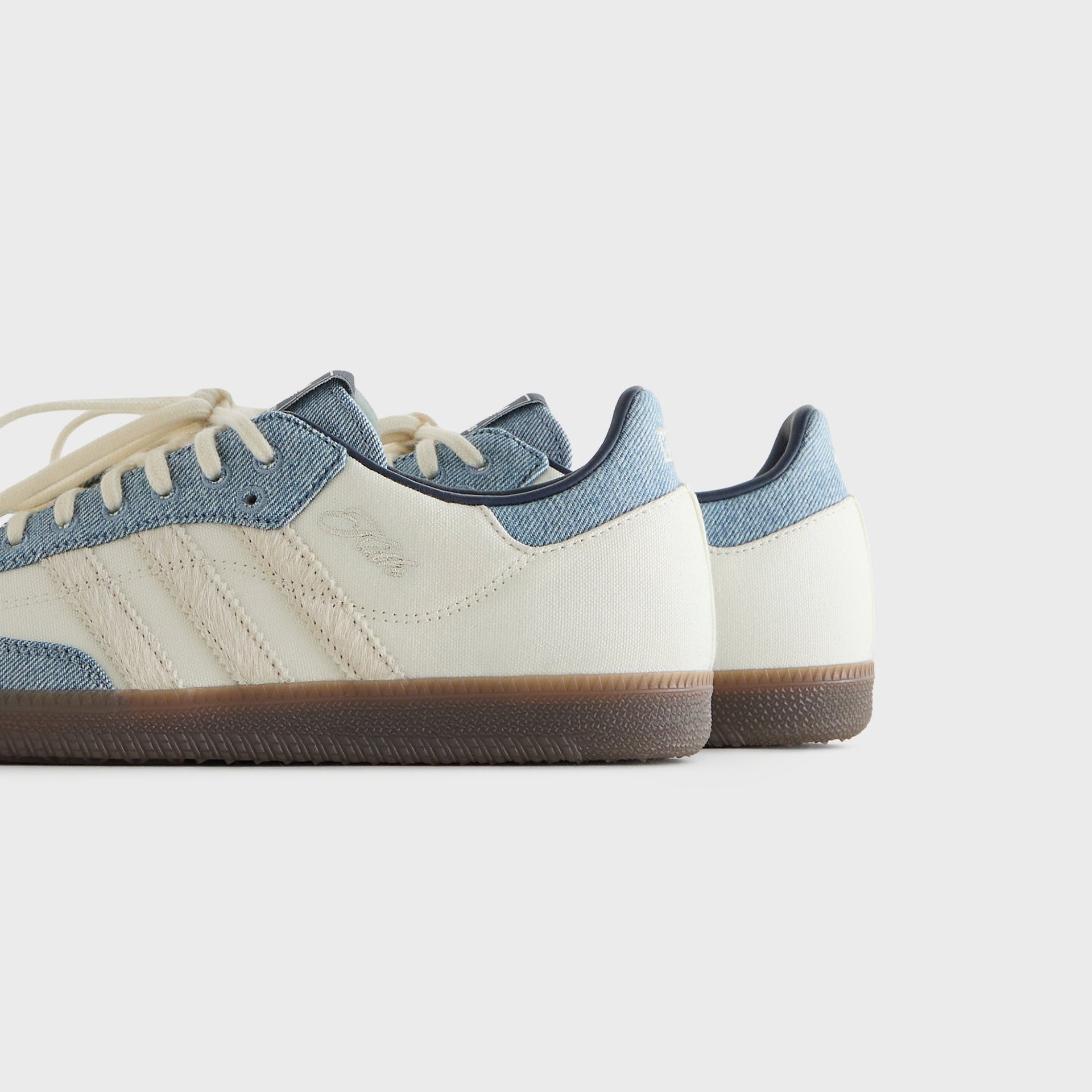 Kith for adidas Originals Samba sneakers in Denim/White, rear three-quarter close-up showing the denim heel collars and cream uppers