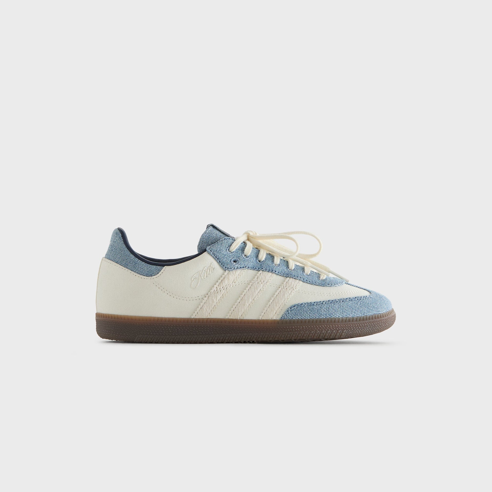 Kith for adidas Originals Samba sneaker in Denim/White, side profile showing the cream canvas quarter and denim overlays with a gum sole