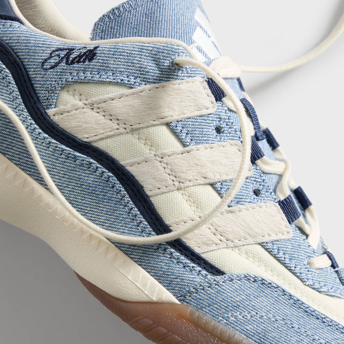 Kith for adidas Football Supernova Indoor in Denim/Gum, close-up of cream pony-hair three stripes on denim with Kith script