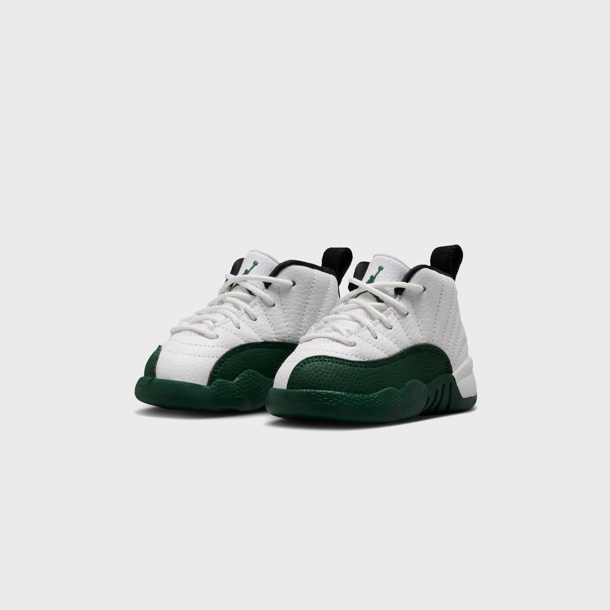 Pair of Jordan TD Air Jordan 12 Retro toddler sneakers in white and green, angled front view