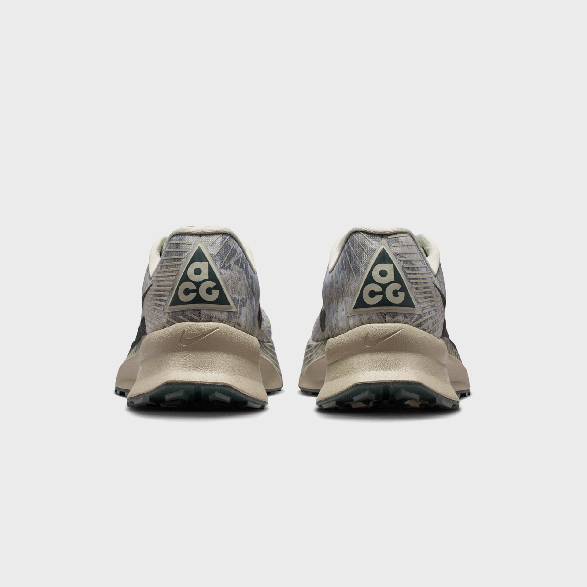 Pair of Nike ACG Ultrafly Trail running shoes, rear heel view with dark green ACG triangle logo patches
