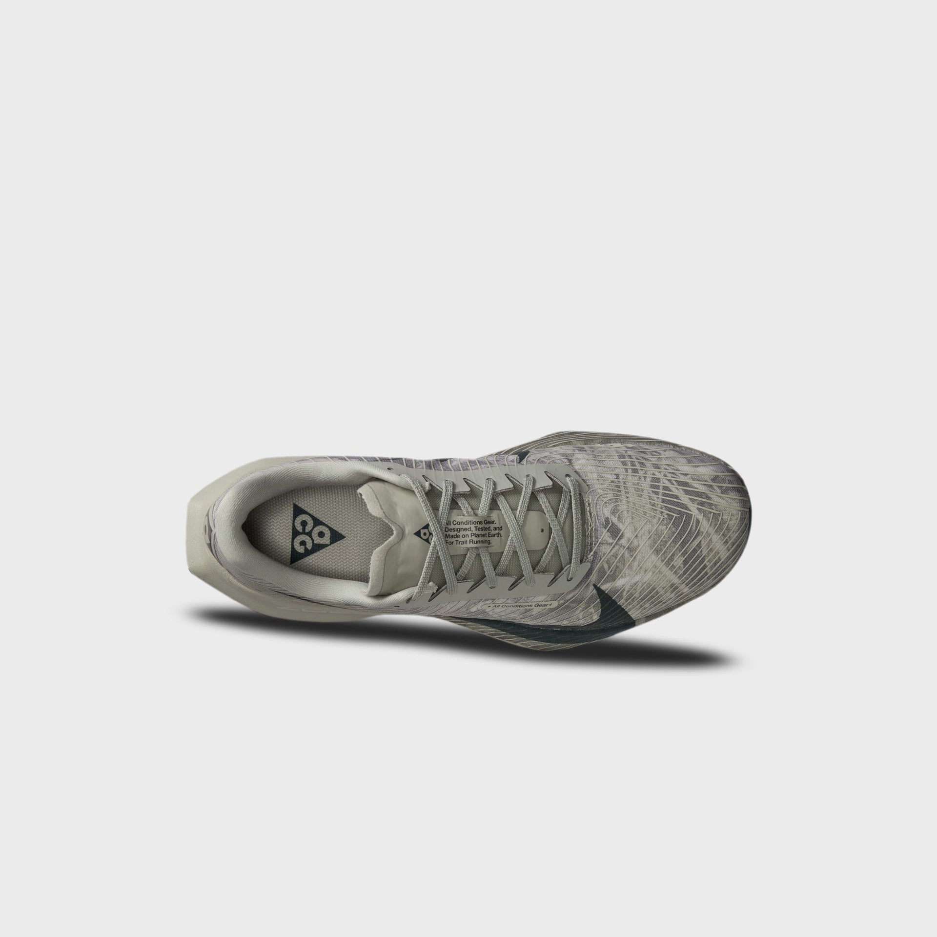 Pair of Nike ACG Ultrafly Trail running shoes in spruce fog camo, angled top-down view showing dark green swoosh overlays