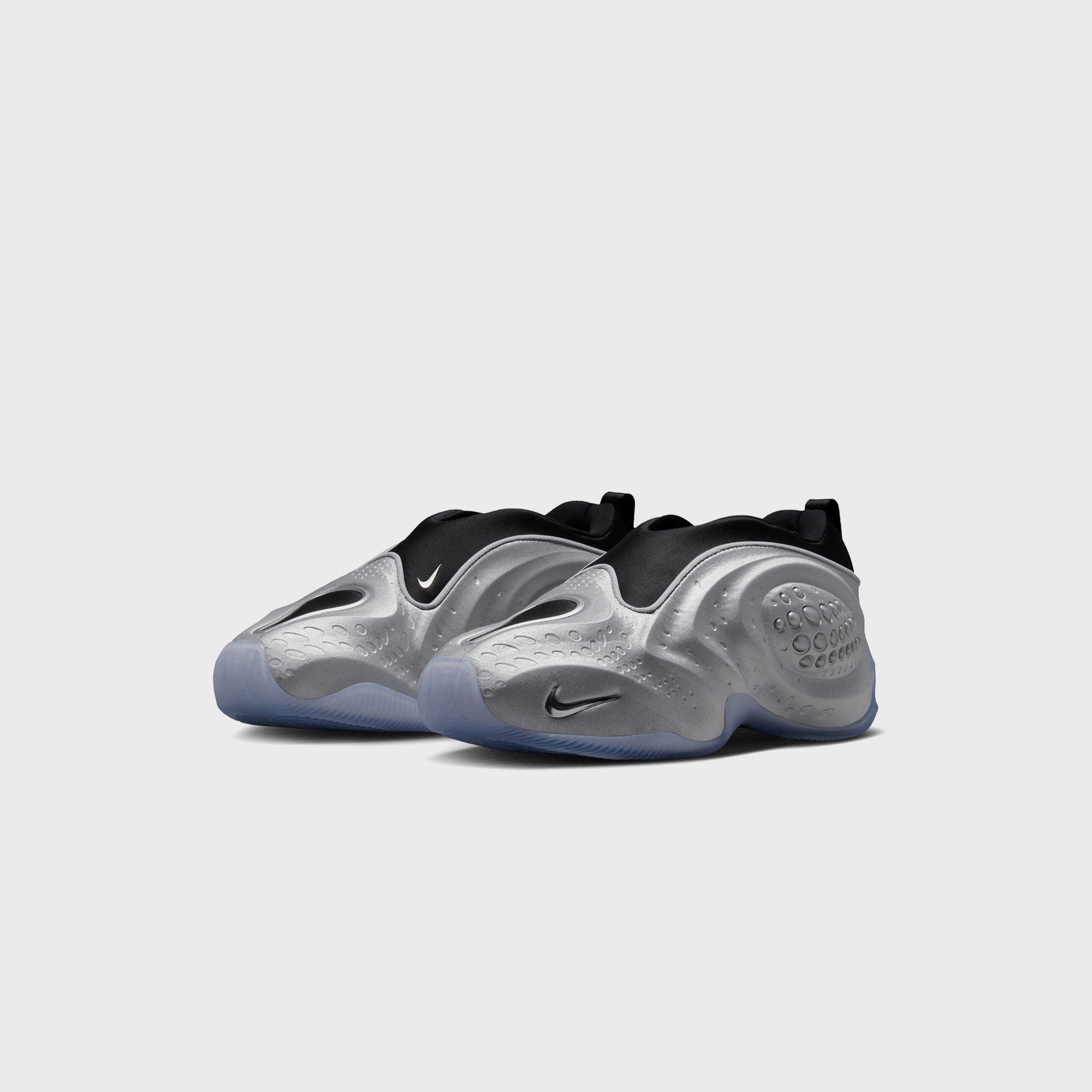 Nike WMNS First Sight Shadow Metallic Silver, front three-quarter view of the pair with metallic shells and clear icy midsoles