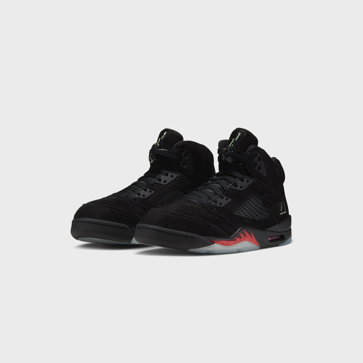 Pair of Jordan Air Jordan 5 Retro black suede sneakers, three-quarter front view with glow-in-the-dark green details