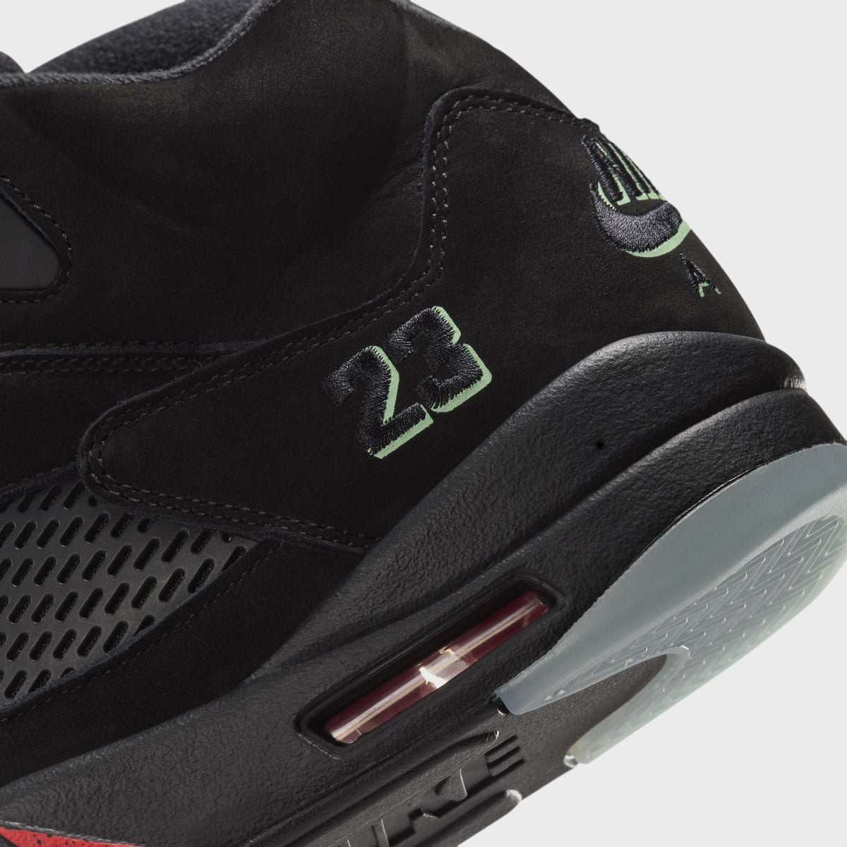 Close-up of Jordan Air Jordan 5 Retro heel showing green 23 and Nike Air embroidery above black midsole