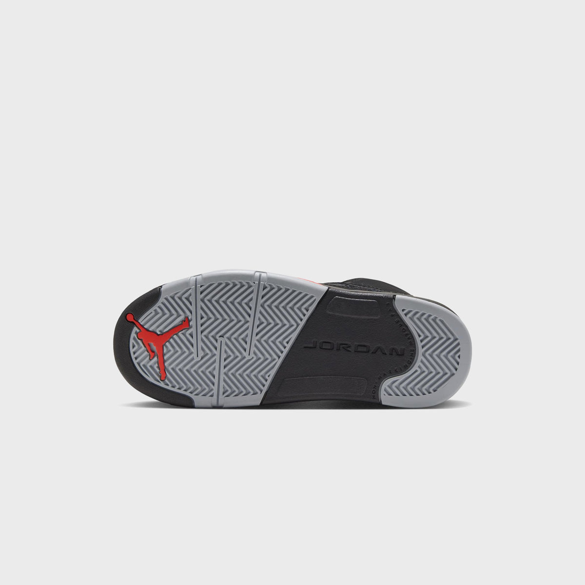 Outsole of Jordan PS Jordan 5 Retro with red Jumpman logo and grey herringbone traction pattern