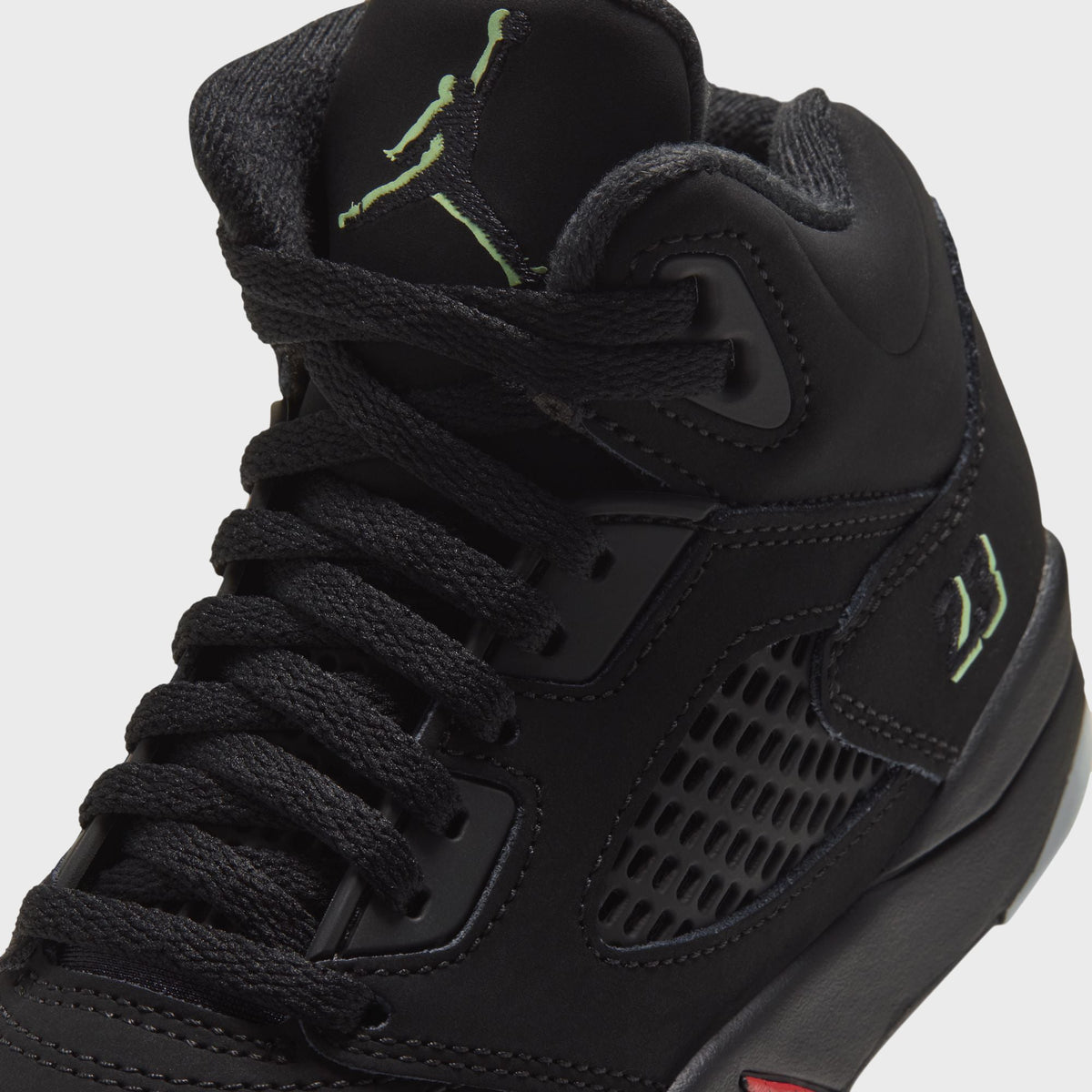 Close-up of Jordan PS Jordan 5 Retro laces, green Jumpman and embroidered 23 on black nubuck