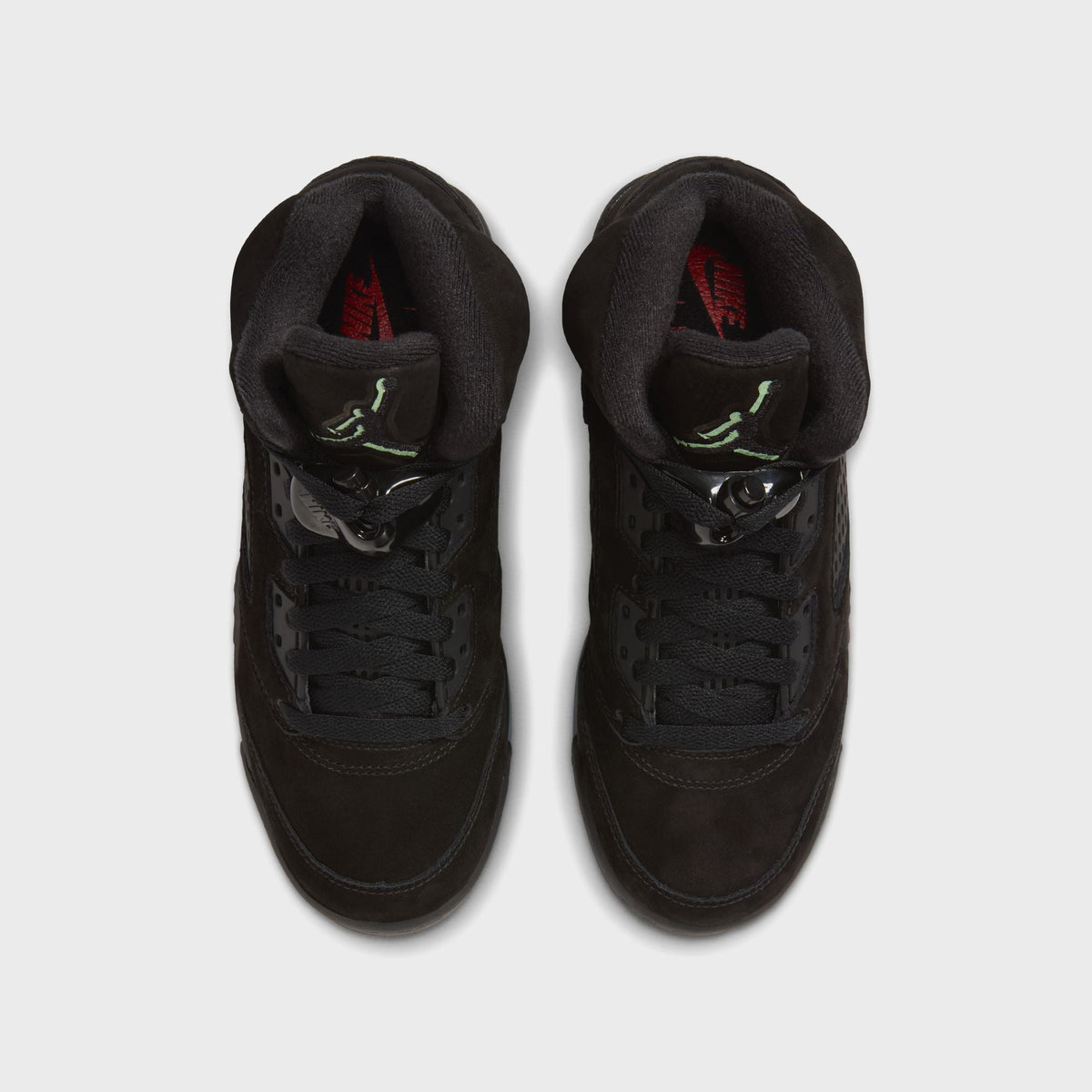 Top-down view of Jordan GS Air Jordan 5 Retro in black suede showing lacing, lace lock and Jumpman tongue logo