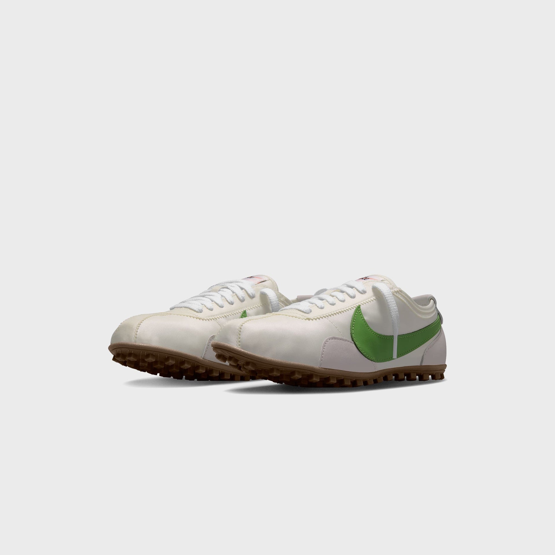 Nike WMNS Moon Shoe pair angled toe-forward, sail nylon uppers with green leather Swooshes and gum soles