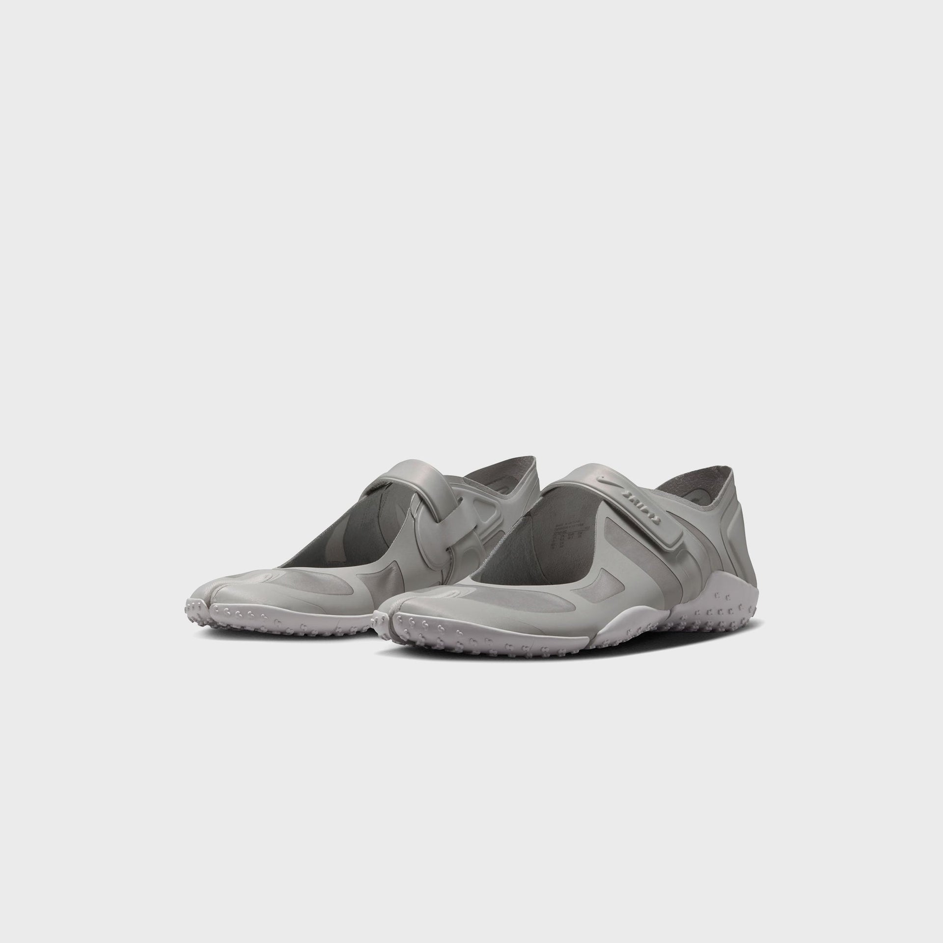 NikeSKIMS Rift Satin sneakers in Night Silver satin, front three-quarter pair view showing tabi split-toe and grey instep strap