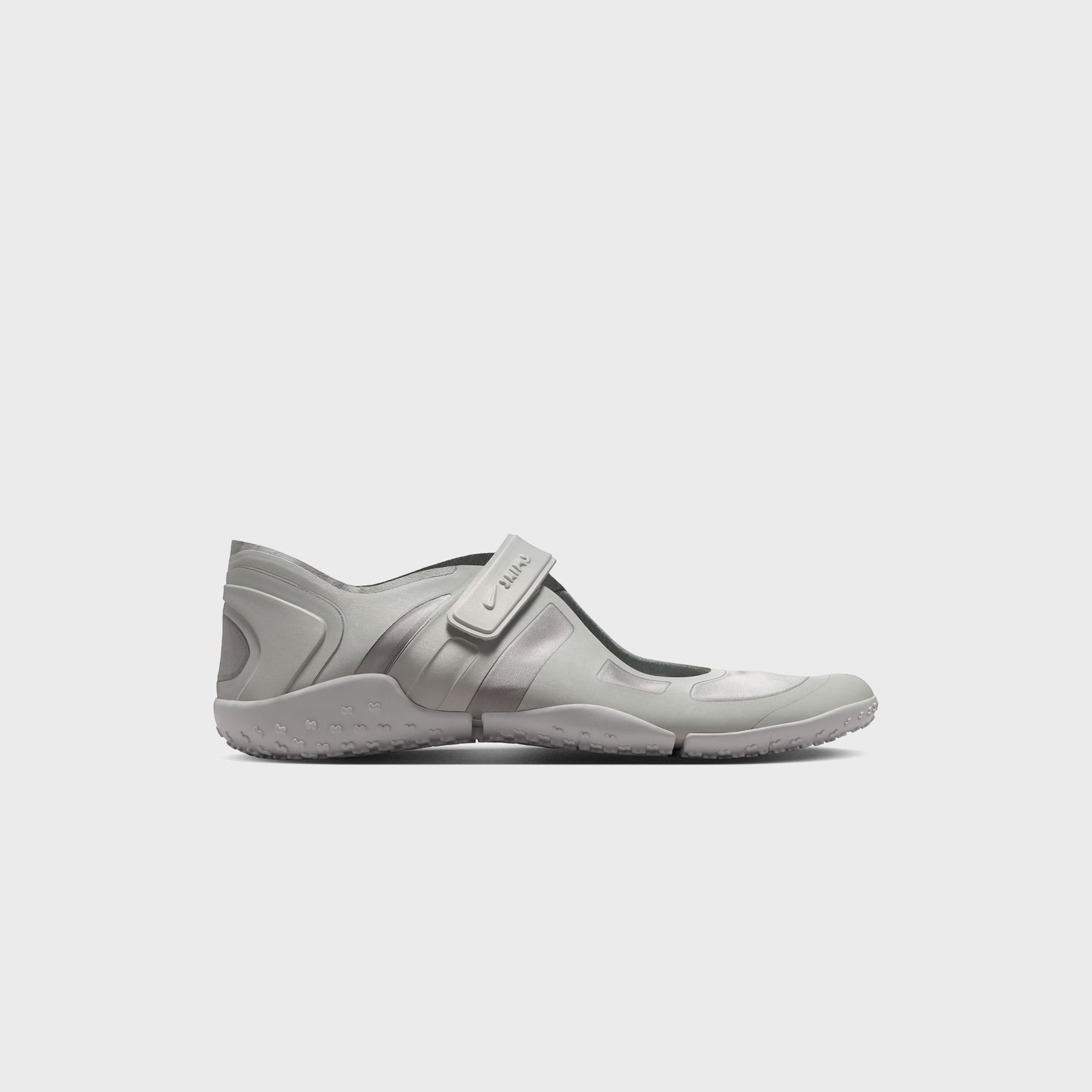 NikeSKIMS Rift Satin split-toe sneaker in Night Silver, lateral side profile with hook-and-loop Swoosh strap and studded outsole