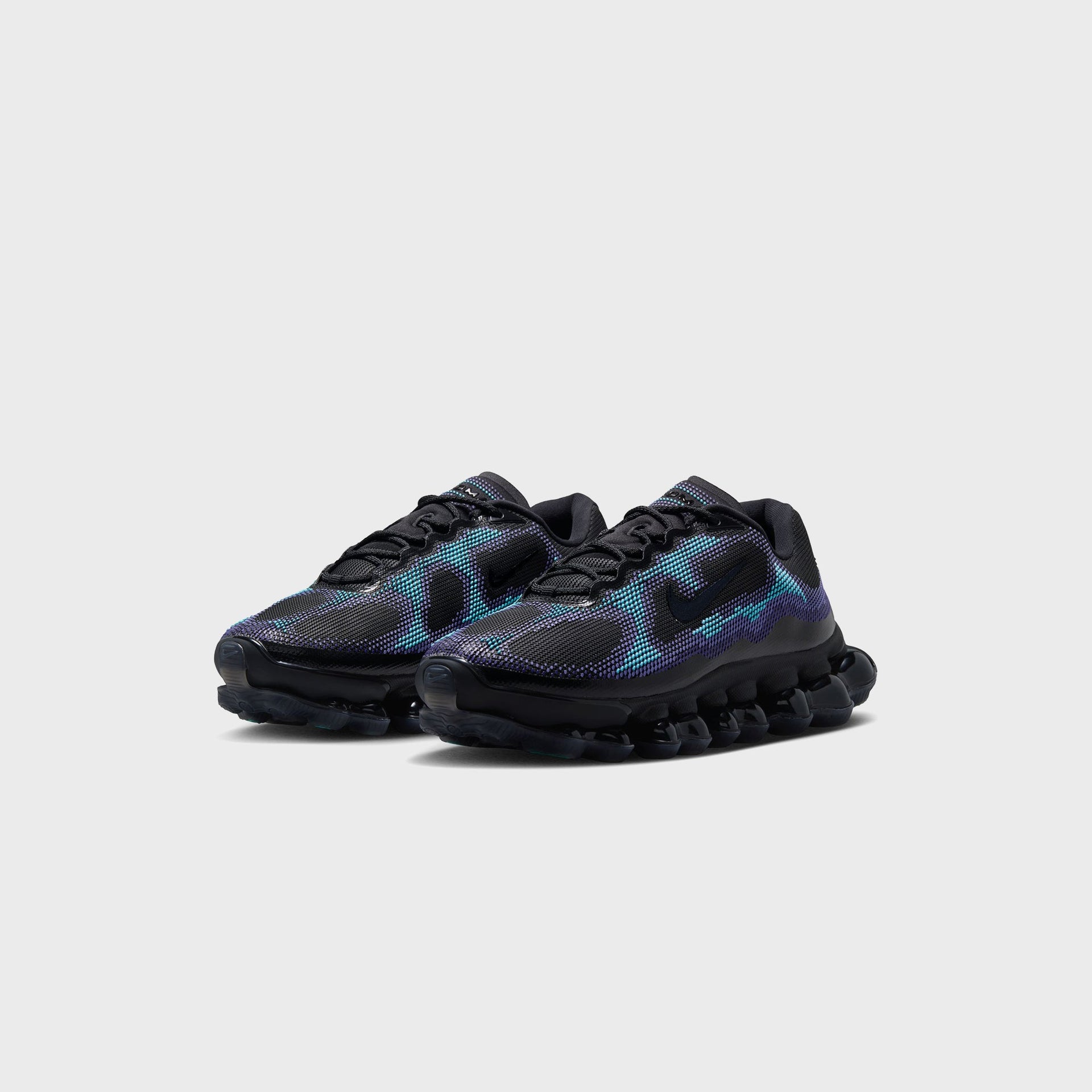 Pair of Nike Air Liquid Max sneakers in black, purple and radiant blue, angled front three-quarter view of both shoes