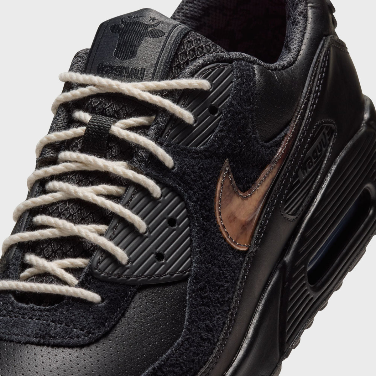 Close-up of Nike x Wagyu Air Max 90 lacing area showing off-white ropelaces and Wagyu tongue patch