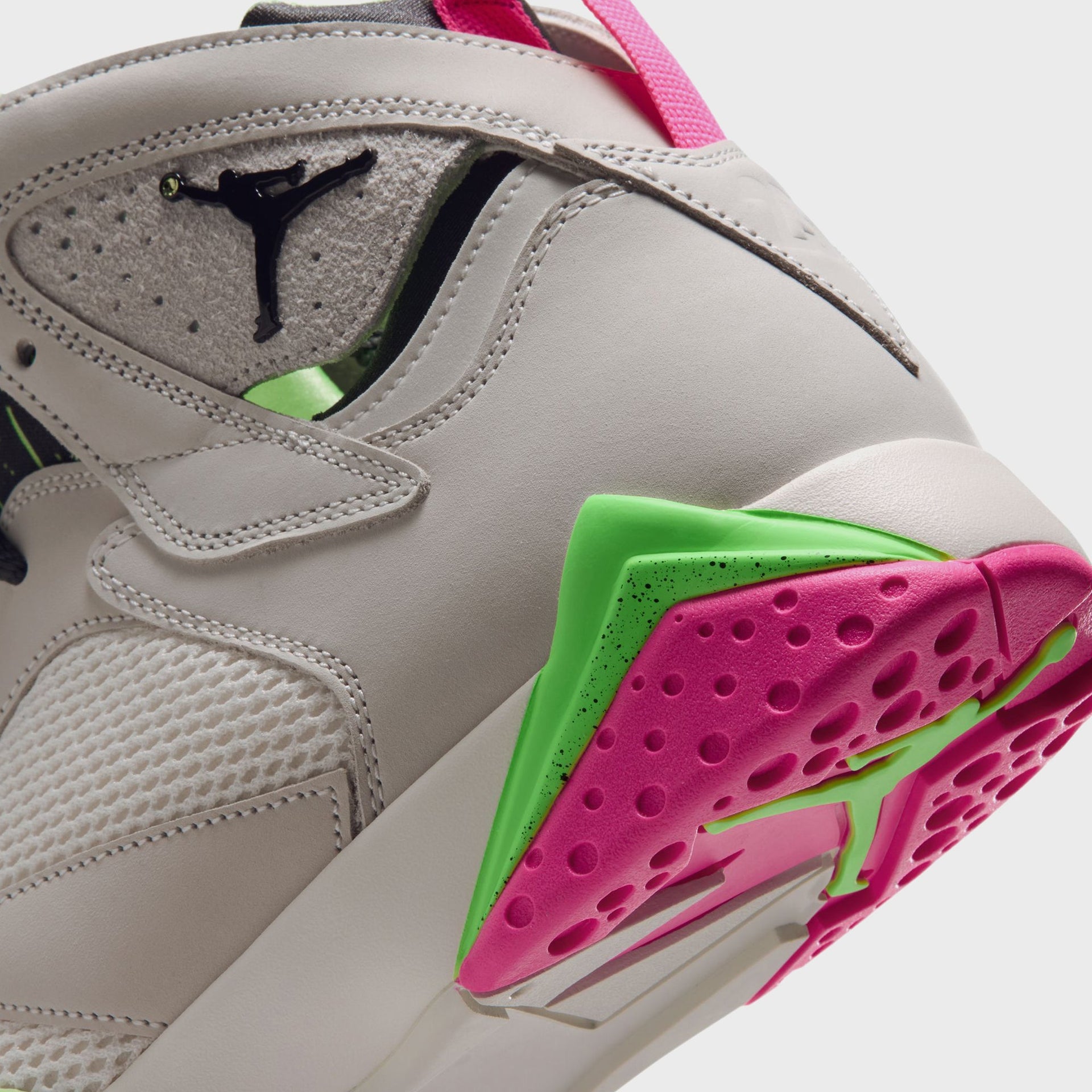 Close-up angled detail of Air Jordan 7 Phantom Lime Blast heel and pink and green midsole