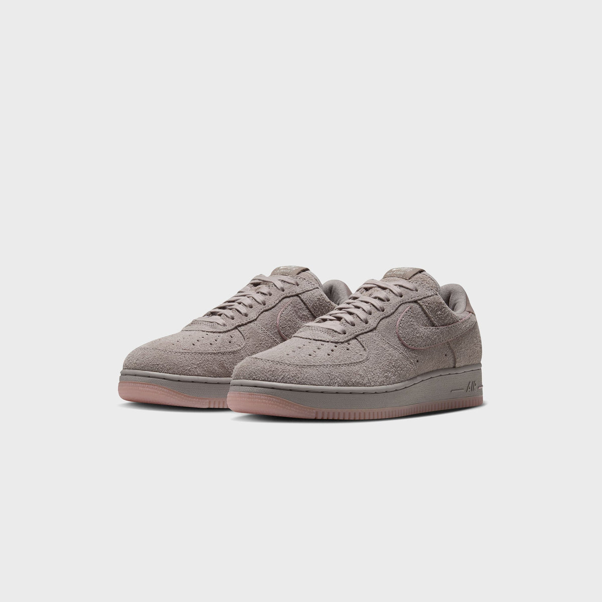 Nike Air Force 1 '01 College Grey / Pink Glaze pair, three-quarter front view, grey suede with pink glaze midsole