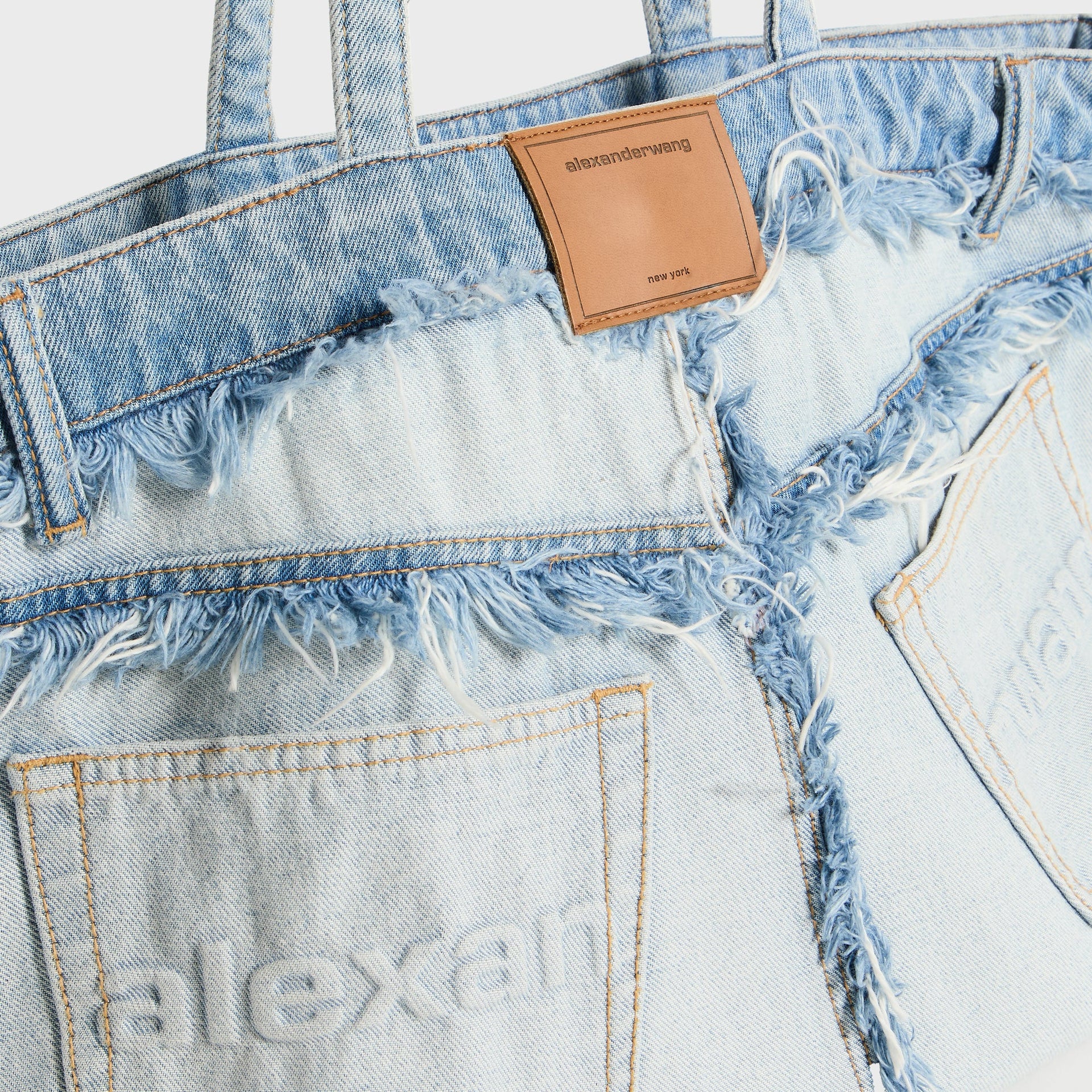 Black leather patch pocket detail with embossed Loewe Anagram logo and whipstitched edges