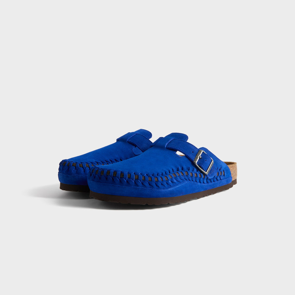 Kith for Birkenstock Boston Braided in Ultra Blue, front three-quarter view of the cobalt suede clog pair with braided toe edges