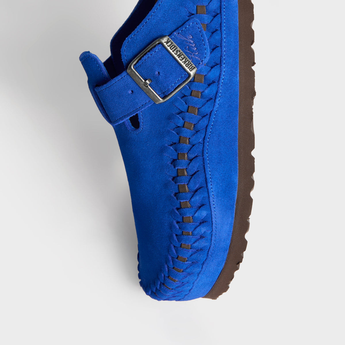 Kith for Birkenstock Boston Braided in Ultra Blue, angled close-up of the buckle strap, braided edge and brown sole