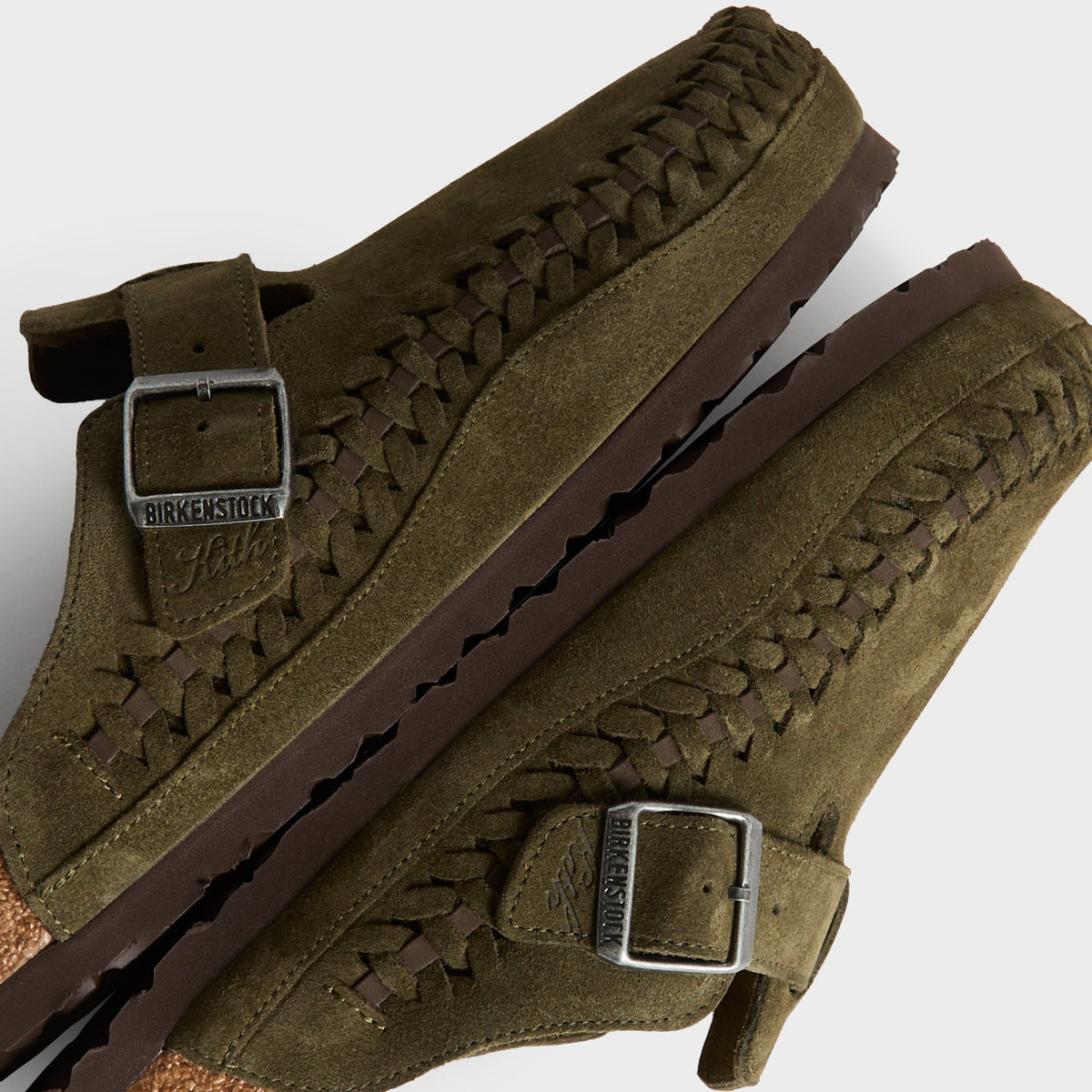 Kith for Birkenstock Boston Braided in Thyme, detail of stacked clogs showing braided welt and Birkenstock x Kith buckles