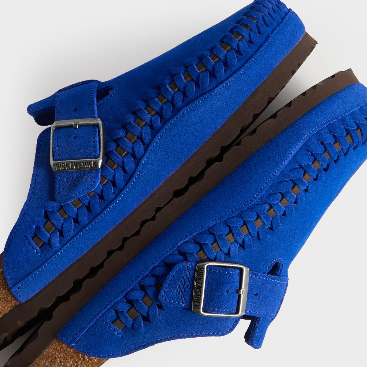 Kith for Birkenstock Women's Boston Braided in Ultra Blue, detail of stacked clogs showing braided welt and Birkenstock x Kith buckles