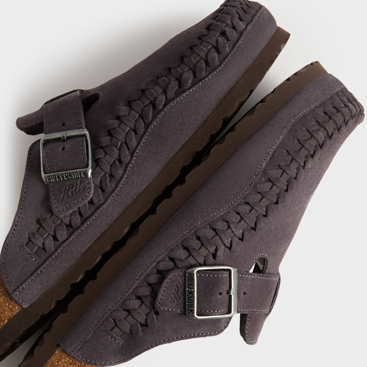 Kith for Birkenstock Boston Braided in Rabbit Grey, detail of stacked clogs showing braided welt and Birkenstock x Kith buckles