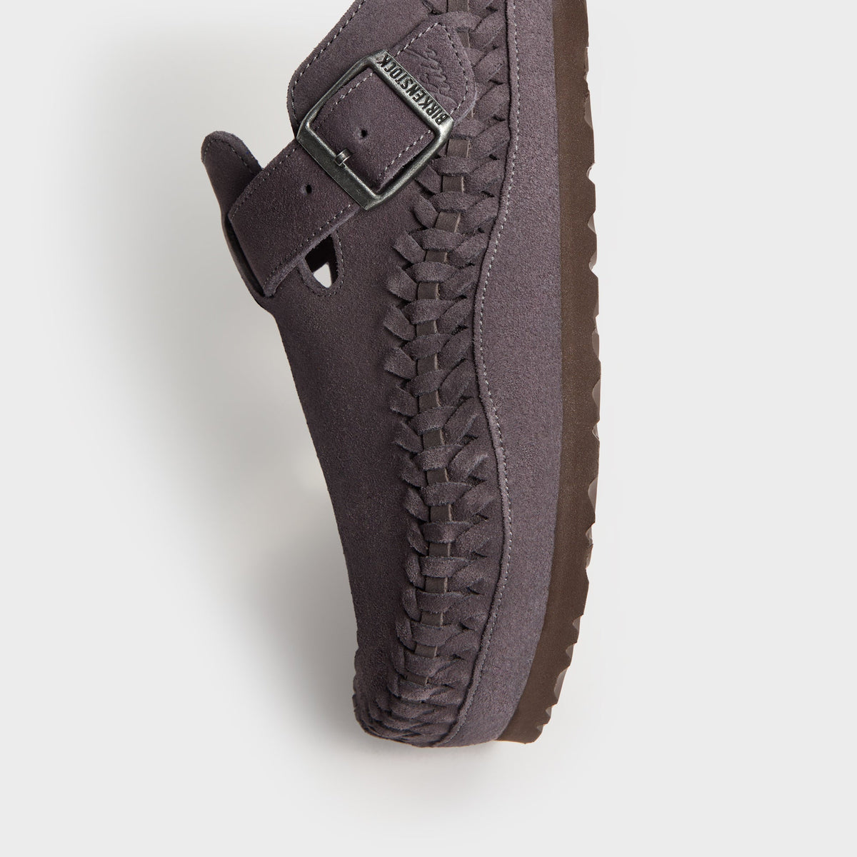 Kith for Birkenstock Boston Braided in Rabbit Grey, angled close-up of the buckle strap, braided edge and brown sole