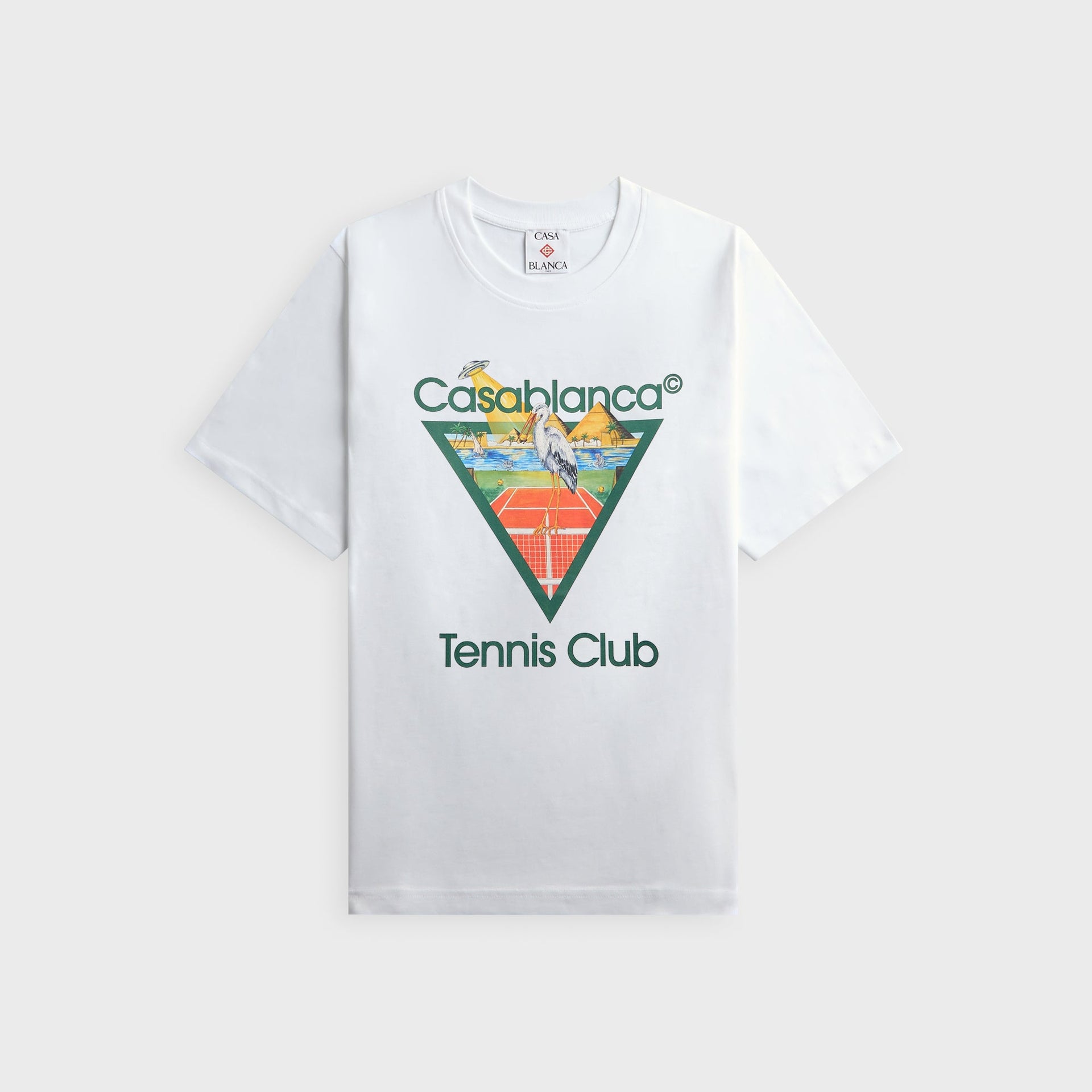 Casablanca Tennis Club white tee, front view with green triangle stork on a tennis court, pyramids and UFO abduction graphic