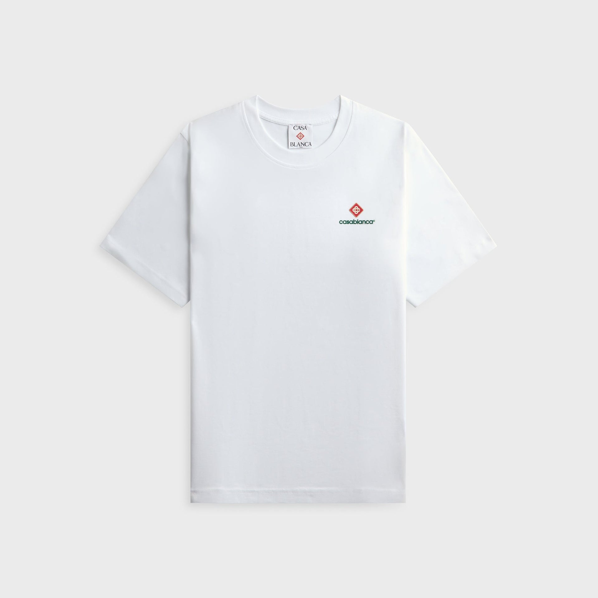 Casablanca Sport Type white tee, front view with small left-chest red diamond monogram and green casablanca wordmark