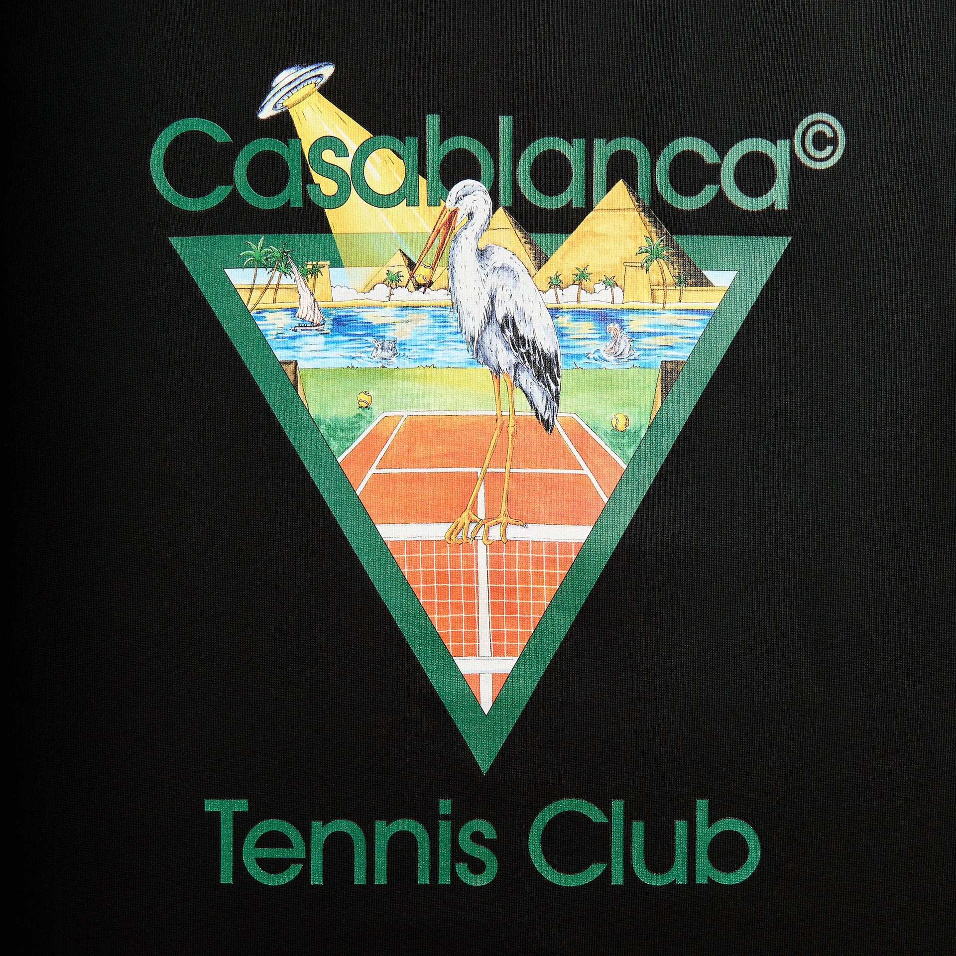 Close-up of Tennis Club graphic: stork on a clay court, pyramids, palm oasis and a UFO beaming down, Casablanca Tennis Club text