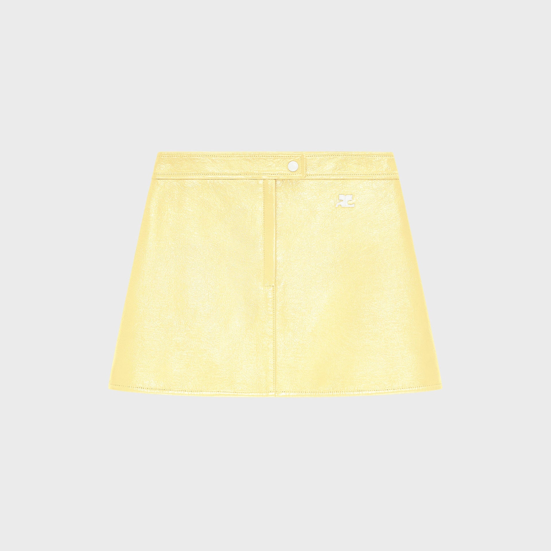 Courreges pale yellow ReEdition vinyl mini skirt with front snap closure and logo patch, flat lay