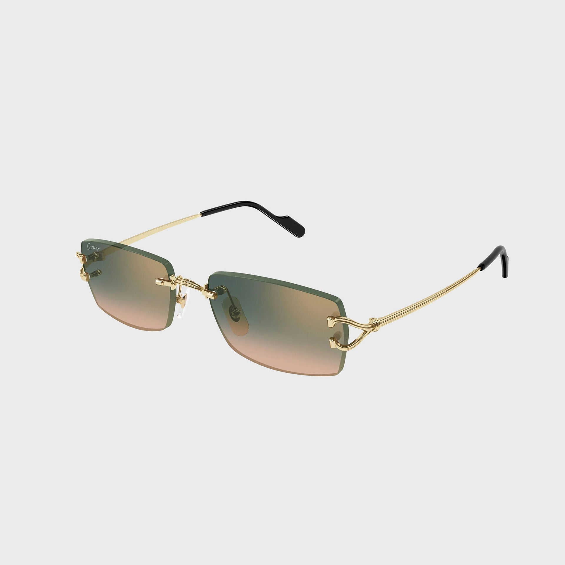 Cartier Decor C rimless rectangular sunglasses with gold C-hinge, green-to-peach gradient lenses and gold arms, angled view