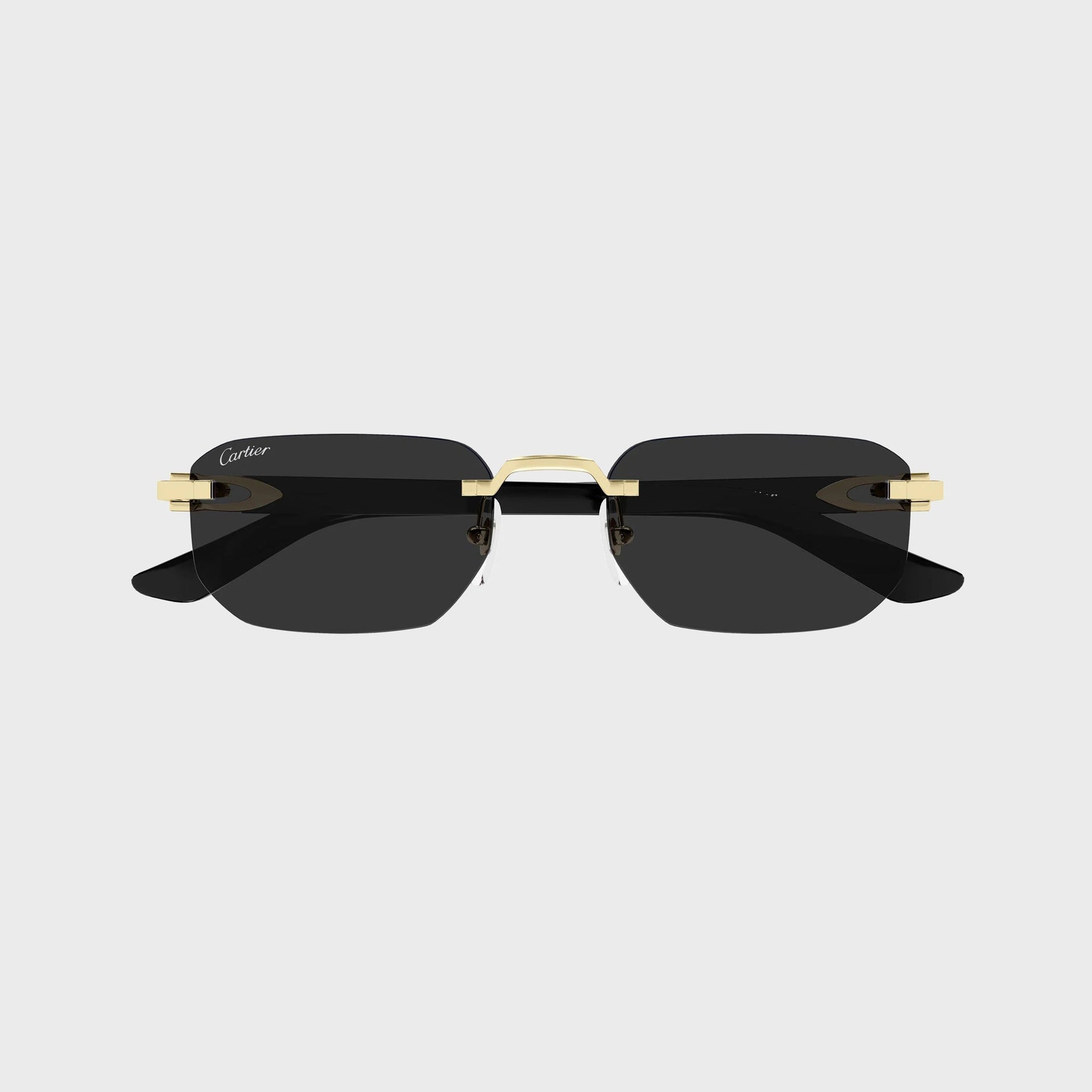 Cartier Decor C rimless rectangular sunglasses in gold with dark grey lenses and black temples, front view