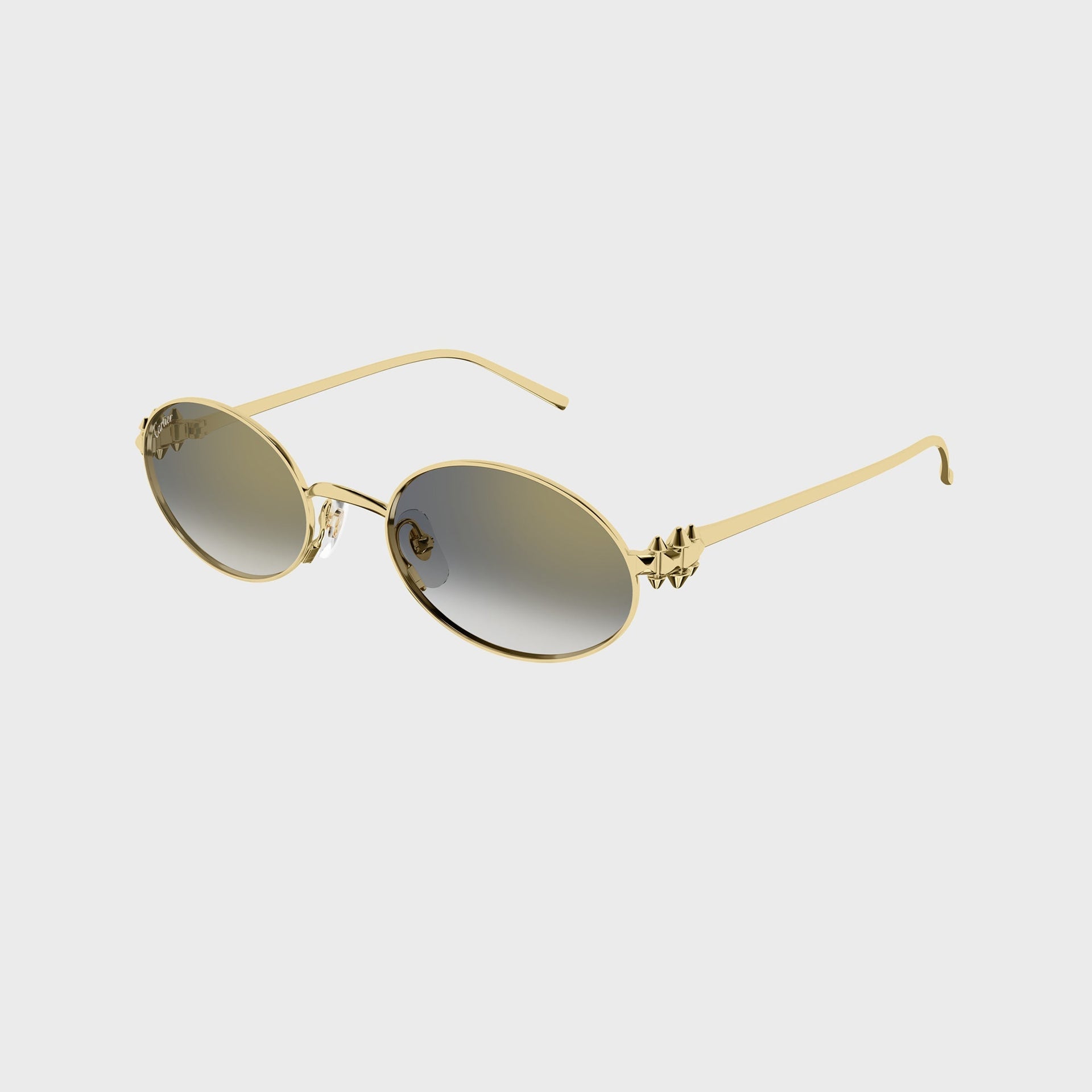 Cartier CT0644S gold oval sunglasses with grey-olive gradient lenses, angled view with studded gold spike temple detail