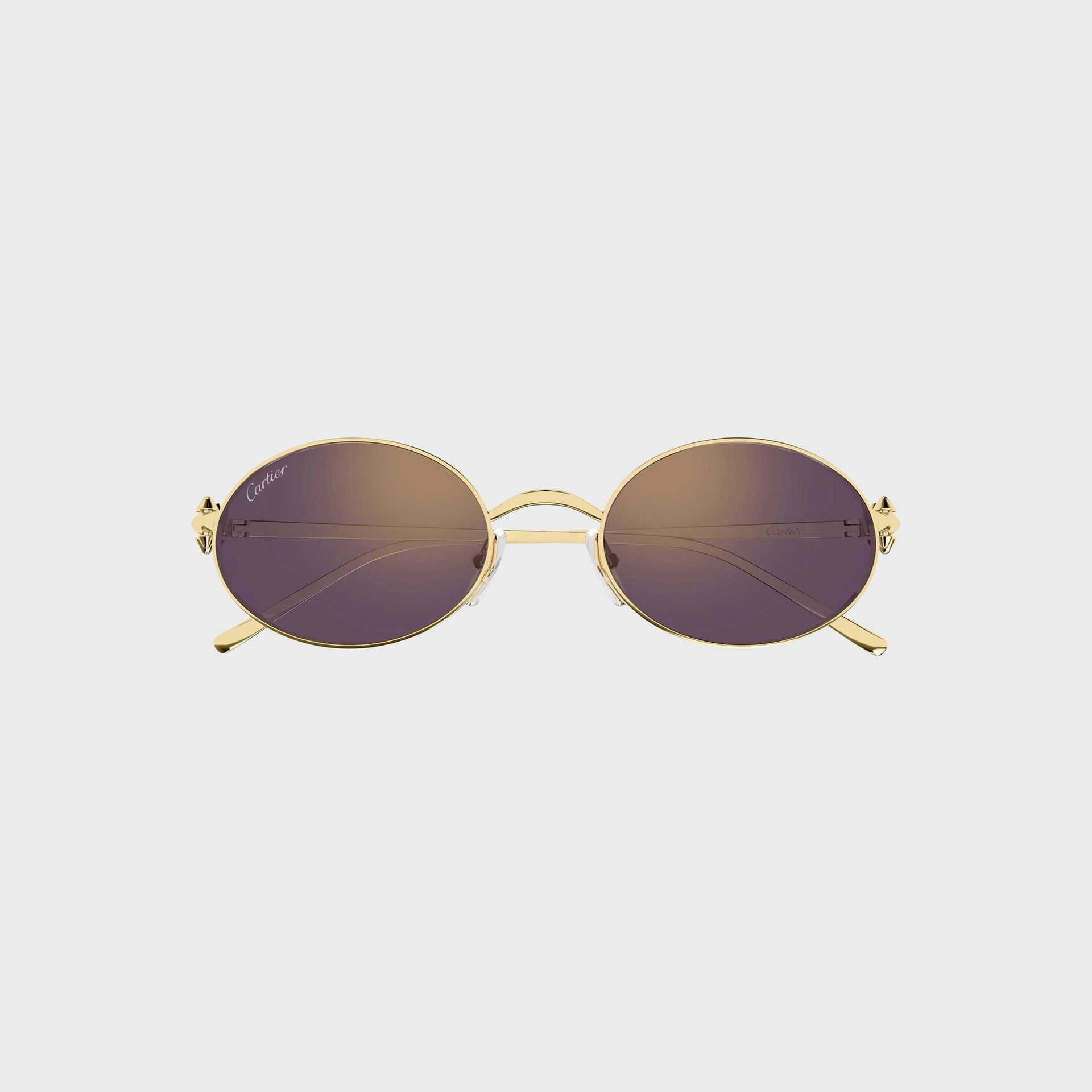 Cartier Clash CT0644S gold oval sunglasses with violet-brown gradient lenses, front view with Cartier script on the lens